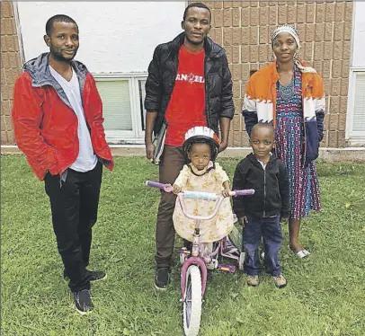  ?? SUBMitteD PHoto ?? Kintu Songolo Ramazani, left, and his brother Jafari, along with Jafari’s wife Mwaliasha and their two children, Rehema, 2, and Abdallah, 4, are making a new home in Sackville. The Congolese family has recently resettled to Canada from the Kakuma...