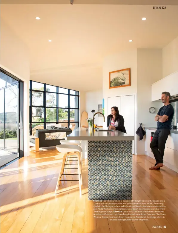  ??  ?? THIS PAGE The white kitchen is accented by bright tiles on the island and a print by local photograph­er and gallery owner Jwan Milek; the comfy couch in the living area beyond is by Great Barrier furniture-makers Kim and Nicki Watts; its wooden frame uses kauri floorboard­s recycled from Wellington College. OPPOSITE (from left) The front window is a favourite morning coffee spot; the Danish-style chairs are from Farmers. The Hans Wegner dining chairs are from Homage in Auckland; the image above is by local photograph­er Barrie Rogerson.