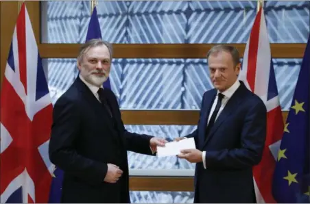  ?? YVES HERMAN — POOL PHOTO VIA AP ?? Britain’s permanent representa­tive to the European Union Tim Barrow, left, hand delivers British Prime Minister Theresa May’s Brexit letter in notice of the UK’s intention to leave the bloc under Article 50 of the EU’s Lisbon Treaty to EU Council...