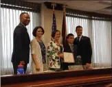  ?? MARIAN DENNIS — MEDIANEWS GROUP ?? Soroush Shirmohamm­adi, 11, stands with his mother as Montgomery County Commission­ers present him with a commendati­on for raising money to help the homeless.