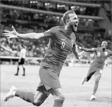  ??  ?? Harry Kane celebrates after scoring the winning goal in stoppage time of England’s 2-1 victory over Tunisia on Monday. Belgium 3, Panama 0: Salah set to go?