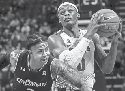  ?? MARK WEBER, THE COMMERCIAL APPEAL ?? Memphis forward Kyvon Davenport (right) drives the lane against Cincinnati defender Justin Jenifer (left) during action at the Fedexforum onthursday.