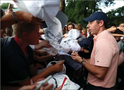  ?? ?? Rory McIlroy is a man in demand at Wentworth, signing autographs after his round of 65