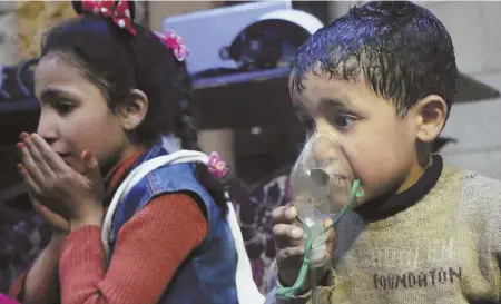  ?? SYRIAN CIVIL DEFENSE WHITE HELMETS VIA AP ?? ‘MINDLESS’: A child receives oxygen through a respirator after an alleged poison gas attack Saturday night in the rebel-held town of Douma, Syria. Syrian rescuers and medics said the attack killed at least 40 people.