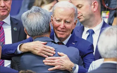  ?? Mario Tama / Getty Images ?? President Joe Biden hugs an audience member at the Boys and Girls Club of West San Gabriel Valley on Tuesday in Monterey Park, California, the scene of a mass shooting where 11 people celebratin­g Lunar New Year in a dance studio were killed.