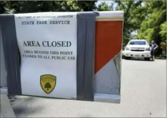  ?? ED MURRAY — NJ ADVANCE MEDIA VIA AP ?? New Jersey State Park police block the entrance to Bulls Island state recreation area during the state government shutdown in Stockton, N.J. , Sunday. New Jersey’s government shutdown dragged into a second day Sunday without a resolution to the...