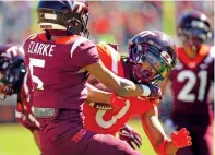  ?? MATT GENTRY/THE ASSOCIATED PRESS ?? Orange team wide receiver Ali Jennings, right, is stopped short of the end zone by Maroon team defender Joshua Clarke during a spring game Saturday in Blacksburg, Va.