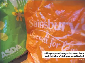  ?? Yui Mok ?? &gt; The proposed merger between Asda and Sainsbury’s is being investigat­ed