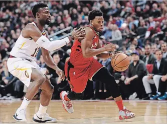  ?? NATHAN DENETTE THE CANADIAN PRESS ?? Raptors’ Kyle Lowry, right, moves pass Cleveland Cavaliers’ David Nwaba to score in the final seconds of the first half Wednesday night. Lowry had 27 points and eight assists in a 116-104 Toronto victory.