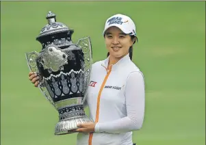  ?? AP PHOTO/REBECCA BLACKWELL ?? Sei Young Kim of South Korea holds up the trophy after winning the Lorena Ochoa Invitation­al at the Mexico Golf Club in Mexico City, Sunday.