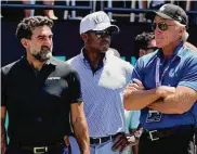  ?? Seth Wenig/Associated Press ?? Yasir Al-Rumayyan, left, governor of Saudi Arabia’s Public Investment Fund, Majed Al-Sorour, CEO of Golf Saudi, center, and Greg Norman, CEO of LIV Golf, watch at the first tee during the second round of the Bedminster Invitation­al in Bedminster, N.J., on July 30.