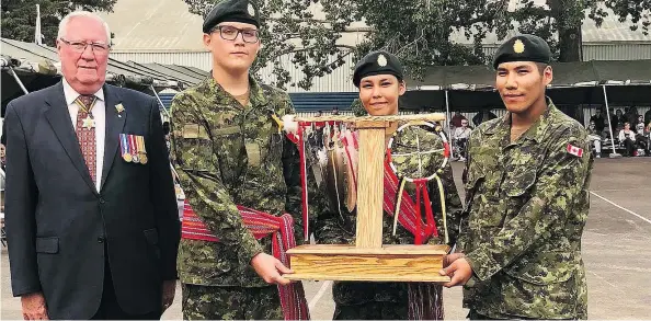  ??  ?? Pte. D. Carrier-henry, centre, from the Taypotat Platoon, Pte. B. Daniels from the Wolfe Platoon and Pte. D. Regnier accept the Second Place Candidate Award on graduation day.