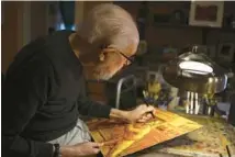  ?? MICHAEL BLACKSHIRE/CHICAGO TRIBUNE ?? Leo Segedin, 95, works on a new painting at his home studio in Evanston on Dec. 19.