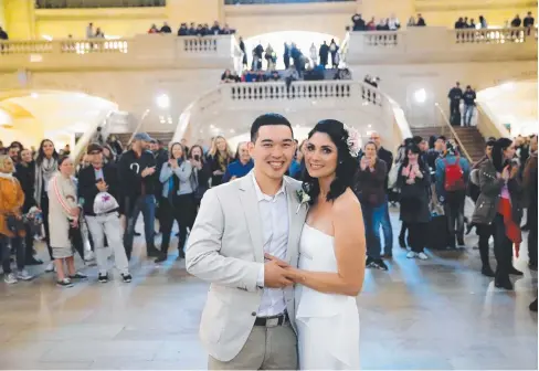  ??  ?? PICTURE PERFECT: Nathan Reilly and Kym Wood of Cairns kept their wedding plans under wraps and eloped to New York, where they tied the knot among commuters amid the marble, bronze and oak splendour of historic Grand Central Station.