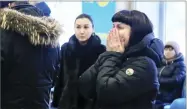  ?? AP PHOTO VIA ORSK.RU ?? In this photo, relatives and friends of those on the Saratov Airlines airline plane An-148 flight that crashed near Moscow’s airport Domodedovo react while gathering at an airport outside Orsk, Russia, Sunday.