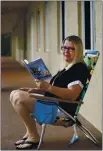  ?? WILFREDO LEE — THE ASSOCIATED PRESS ?? Kelly Vaiman sits along a walkway to her home where she likes to sit and read, on Feb. 19 in Boynton Beach, Fla. Vaiman is an avid cozy mystery reader.