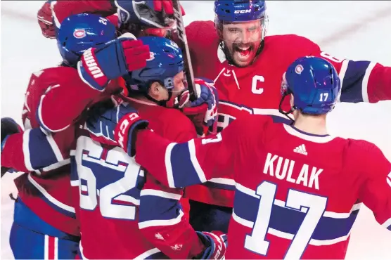  ?? DAVE SIDAWAY ?? Canadiens captain Shea Weber celebrates Phillip Danault’s goal with teammates Tuesday, his first game in nearly a year after recovering from an injury and surgery.