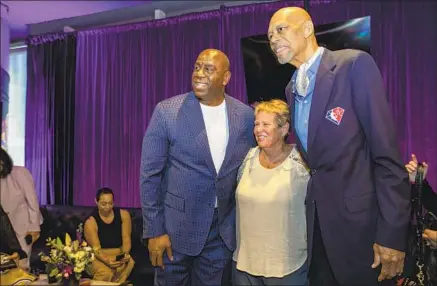  ?? Francine Orr Los Angeles Times ?? ANN MEYERS, middle, with Magic Johnson and Kareem Abdul-Jabbar, followed up a Hall of Fame playing career by becoming a broadcaste­r. She cites playing at UCLA with her older brother Dave for helping draw attention to herself and women’s basketball.