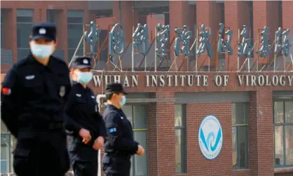  ?? Photograph: Thomas Peter/Reuters ?? Security guards outside the Wuhan Institute of Virology. Pressure has increased to investigat­e the lab-leak theory more thoroughly.