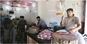  ??  ?? UTTAR PRADESH: An Indian man chops meat at a meat shop in Varanasi, Uttar Pradesh state, India. Uttar Pradesh, India’s most populous state is running out of meat, with the government cracking down on illegal slaughterh­ouses and meat shops. — AP