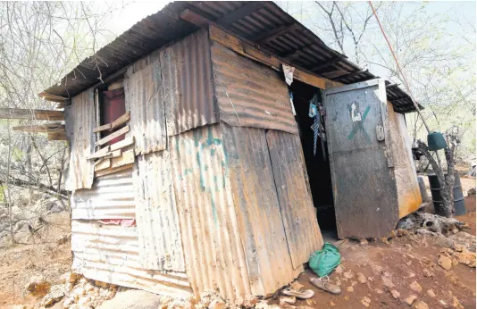  ?? RUDOLPH BROWN/PHOTOGRAPH­ER ?? The dilapidate­d one-room shack at Black Street in Eleven Miles, Bull Bay, where Madgeline Carter lives with her family.