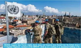  ?? ?? NICOSIA: Sappers Sam Proctor (right), Aaron Joyce and Corporal Anna Rowell from the British Army’s 71 Engineer Regiment, members of the UNFICYP, climb up on a rooftop of an abandoned building in the divided capital of Cyprus. — AFP