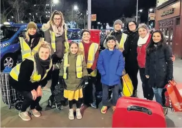  ?? with a team of volunteers ?? Amaarah Mian-cudmore packs a backpacks and, above centre, handing them out to homeless people