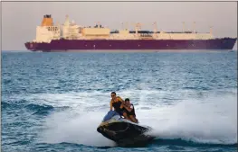  ?? AMR NABIL— THE ASSOCIATED PRESS ?? A ship crosses the Gulf of Suez as tourists ride a jet ski in 2019. Not only are humans changing the surface and temperatur­e of the planet, but also its sounds – and those shifts are detectable even in the open ocean, according to a study.