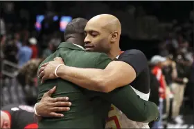  ?? THE ASSOCIATED PRESS FILE ?? Hawks guard Vince Carter, right, hugs former Hawk Dominique Wilkins as he leaves the court following a game.
