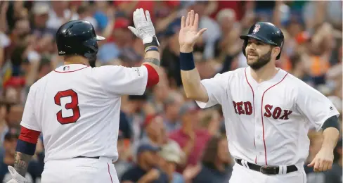  ?? (Photo by Michael Dwyer, AP) ?? Boston Red Sox’s Sandy Leon (3) congratula­tes former Mississipp­i State player Mitch Moreland, who scored during the seventh inning Sunday in Game 3 against the Houston Astros.