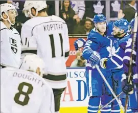  ?? Nathan Denette Associated Press ?? TORONTO CENTER Patrick Marleau, second from right, celebrates with teammate Josh Leivo after scoring a power-play goal in the first period Monday.