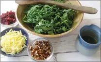  ?? The Associated Press ?? The components of this arugula salad include spicy pecan praline, dried cranberrie­s and aged gouda in New York.