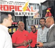  ?? PHOTO BY CHRISTOPHE­R SERJU ?? Daniel Melville ((left), sales and marketing manager at Tropical Battery Limited, gets an update on Government’s efforts to diversify the energy source mix from Dr Andrew Wheatley (right), minister of energy, science and technology, during Wednesday’s...