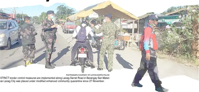  ?? PHOTOGRAPH COURTESY OF ILOCOS NORTE POLICE ?? STRICT border control measures are implemente­d along Laoag-Sarrat Road in Barangay San Mateo as Laoag City was placed under modified enhanced community quarantine since 27 November.