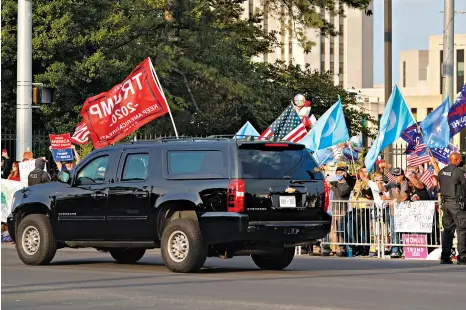  ??  ?? OCT. 4: Trump’s motorcade drove past crowds outside Walter Reed medical center.