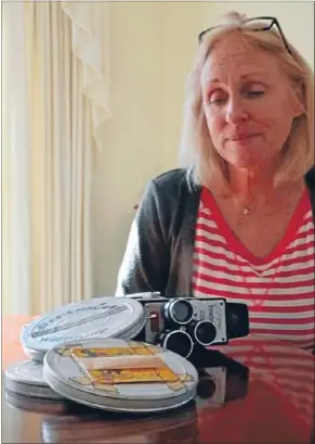  ?? Photo: MATT SHAND ?? Movies mystery: Cathy Serrier of Tawa with her grandfathe­r’s 8mm camera and three films that escaped the tip.