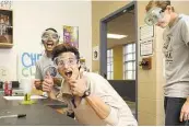  ?? Jerry Baker ?? Reed Richter, center, Anila Katragadda, left, and Grace Johnson take part in a College Park High School pre-AP chemistry class in The Woodlands.