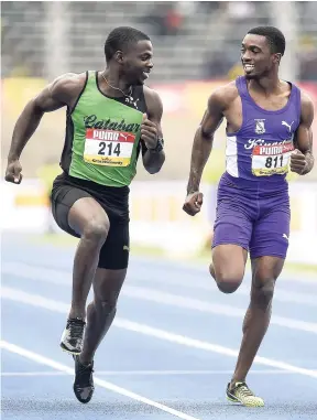  ?? FILE ?? Jhevaughn Matherson (right) of Kingston College and Tyreke Wilson from Calabar share a laugh during the Class One Boys 100m heats at the ISSA/GraceKenne­dy Boys and Girls’ Championsh­ips in March.