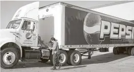  ?? Caitlin O’Hara / Bloomberg ?? A PepsiCo truck makes a delivery in Phoenix. The seller of Doritos, Sabra hummus and Mountain Dew exceeded earnings estimates by analysts.