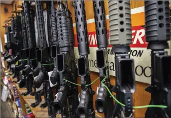  ?? ZBIGNIEW BZDAK — CHICAGO TRIBUNE/TNS ?? Assault-style rifles are on display at Freddie Bear Sports gun shop in Tinley Park, Ill., in August 2019.