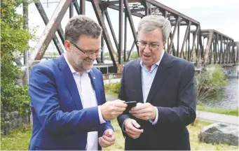  ?? JEAN LEVAC ?? Mayor Jim Watson and the Gatineau Mayor Maxime Pedneaud-Jobin hold a news conference near the Prince of Wales Bridge. Several letter writes says the bridge should be an Ontario-Quebec transit link.