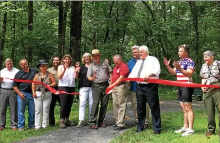  ?? REBECCA BLANCHARD — DIGITAL FIRST MEDIA ?? Representa­tives of the Schuylkill Highlands Conservati­on Landscape, their partners, community leaders, and politician­s celebrate the opening of the new trail which connects Hopewell Big Woods to French Creek State Park. This is a handicap accessible...