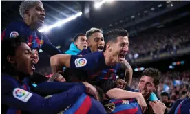  ?? Álex Caparrós/Getty Images ?? Franck Kessié is mobbed after scoring Barcelona’s dramatic winner in the clásico. Photograph: