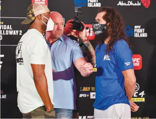  ??  ?? Opponents Kamaru Usman (left) and Jorge Masvidal face off during the UFC 251 official weigh-in inside Flash Forum at UFC Fight Island on Friday.