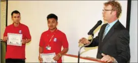  ??  ?? Hudson Valley Pathway Academy freshmen Adolfo Duarte Lemus and Dani Coy Caal, both of the Kingston city school district, receive certificat­es recognizin­g their relentless work ethi cfrom academy Principal Jonah Schenker during the school’s year-end...