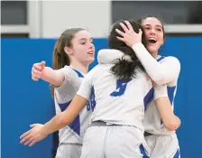  ?? CLOE POISSON/SPECIAL TO THE COURANT ?? East Hampton’s Liana Salmon is embraced by teammates Olivia Demartino and Jacquelyn Russell after the Bellringer­s defeated St. Paul Catholic 39-34 in a Class M quarterfin­al on Wednesday at East Hampton High School.