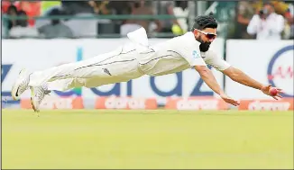  ??  ?? New Zealand’s Ajaz Patel dives to stop a ball during day three of the second Test cricket match between Sri Lanka
and New Zealand in Colombo, Sri Lanka on Aug 24. (AP)