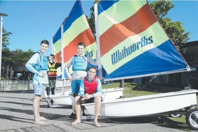  ??  ?? Cairns Yacht Club members Darcy Oates, 15, Mathew Christense­n, 15, Harrison Oates, 17 and Ruben Hammond, 16 with two of the new sailing boats. Picture: Stewart McLean