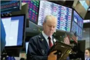  ?? RICHARD DREW — THE ASSOCIATED PRESS ?? Trader James Riley works on the floor of the New York Stock Exchange, Wednesday.