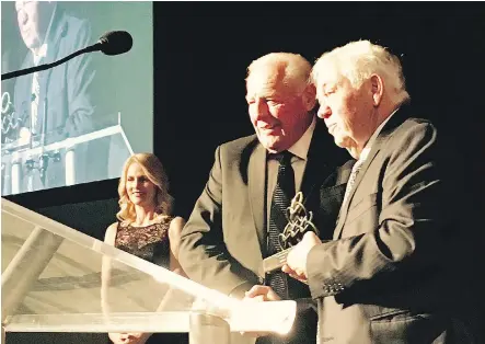  ??  ?? Shane Homes Group of Companies CEO and CVO Cal Wenzel, left, is welcomed to the Calgary Business Hall of Fame by Junior Achievemen­t Southern Alberta at a gala event in Calgary earlier this month. With his business success, Wenzel has also made...